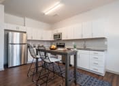 Thumbnail 3 of 35 - a kitchen with white cabinetry and stainless steel appliances at East 51 At Rocketts Landing, Richmond, 23231