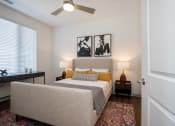 Thumbnail 5 of 35 - a bedroom with a bed and a desk at East 51 At Rocketts Landing, Richmond, 23231