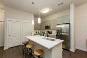 Thumbnail 16 of 30 - Kitchen with granite countertops and stainless steel appliances at Proximity Apartments, South Carolina, 29414