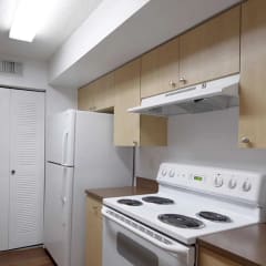 a kitchen with white appliances and a refrigerator