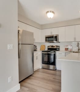 the preserve at ballantyne commons apartment kitchen and dining area with stainless steel appliances
