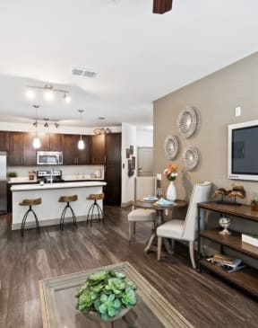 our apartments offer a living room with a couch a coffee table and a flat screen tv