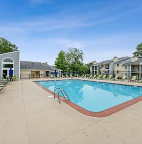 a swimming pool with tables and chairs with umbrellas at Chinoe Creek Apartments, Lexington, KY, 40502