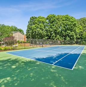 a park with a playground and a tennis court at Woodcreek Apartments, North Carolina