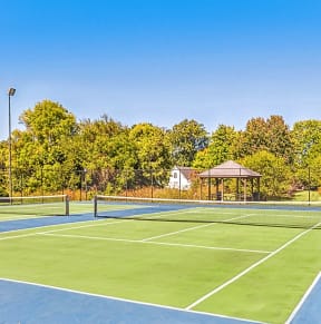 the tennis courts are equipped with a gazebo and gated tennis courts