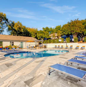 our resort style swimming pool is filled with lounge chairs and umbrellas at Edgemont Apartments, PRG Real Estate, Greenville, 29615