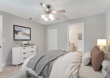 a bedroom with a bed and a ceiling fan