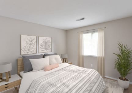 our apartments offer a bedroom with a bed and a plant at Chinoe Creek Apartments in Lexington KY