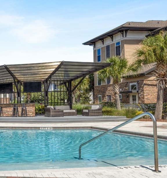 Resort-style swimming pool with lights at The Loree, Jacksonville, FL