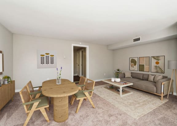 a living room with a couch and a table and chairs