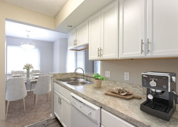 a kitchen with white cabinets and a coffee maker on the counter at Chinoe Creek Apartments in Lexington KY