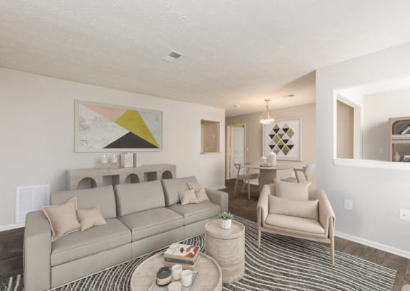 a living room and dining room with a couch and chairs and a table at Edgemont Apartments, PRG Real Estate, Greenville, 29615
