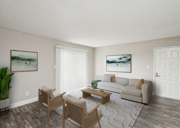 the living room of an apartment with a couch and chairs