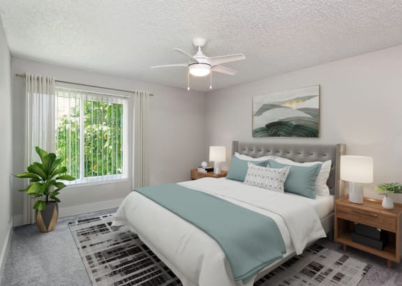 a bedroom with a bed and a ceiling fan