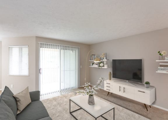 a living room with a couch and a table and a television at Chinoe Creek Apartments in Lexington KY