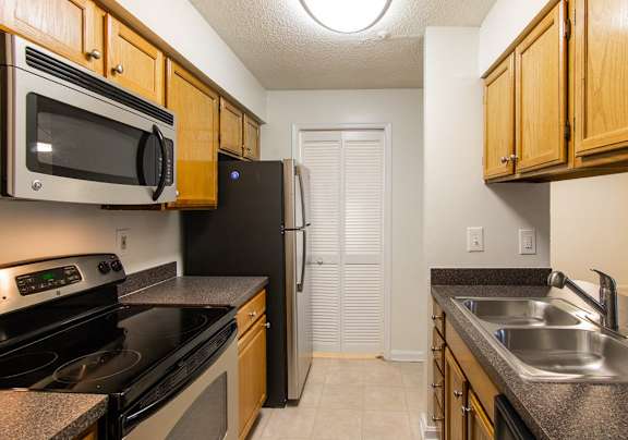 a kitchen with a stove refrigerator and sink
