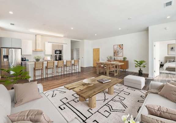 A modern living room with a white sofa, wooden coffee table, and a rug with black lines.