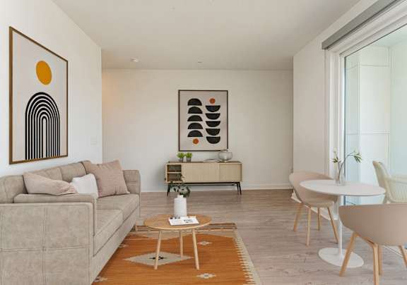 A living room with a tan couch and a coffee table at The Box, Richmond, VA, 23224