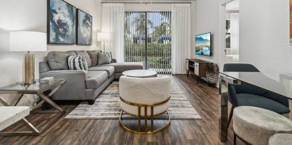 the living room of an apartment with a couch and a chair  at Barcelona Jupiter, Jupiter, FL