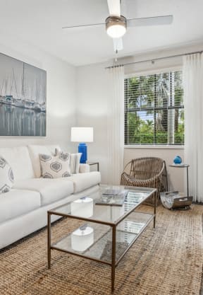 a living room with a white couch and a glass coffee table at Barcelona Jupiter, Florida, 33458