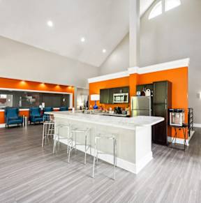 the preserve at ballantyne commons clubhouse with kitchen and living room