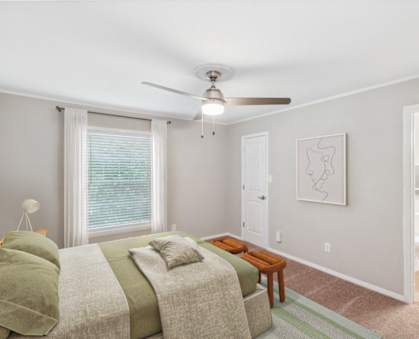 a living room with a couch and a ceiling fan