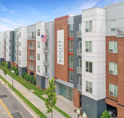 an aerial view of a large apartment building with a sign that reads lofts on the side