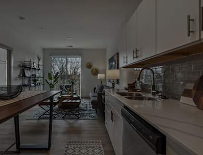 a kitchen and living room with a sink and a table