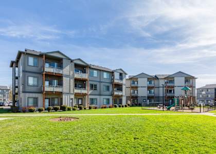 Apartment complex with a playground in the front yard at Fruitland Meadow Apartments, Salem, Oregon