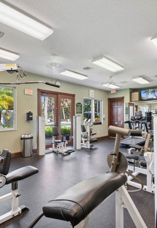 a gym with weights and cardio equipment at the enclave at woodbury at Gateway Club, Florida, 33436