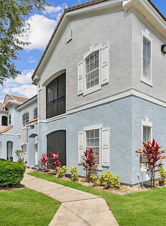 a house with palm trees in front of it  at Ballantrae Apartments, Florida, 32771