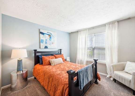 the preserve at ballantyne commons apartment bedroom with bed and chair
