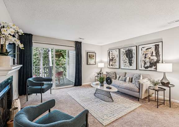 a living room with chairs and a fireplace and a television at Park Ridge Estates, North Carolina, 27713