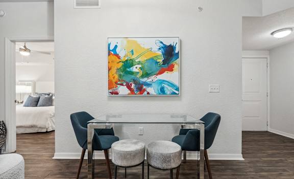 a dining room with a glass table and four chairs at Barcelona Jupiter, Jupiter, FL