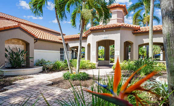 a villa with palm trees and a walkway at Via Lugano, Boynton Beach, FL
