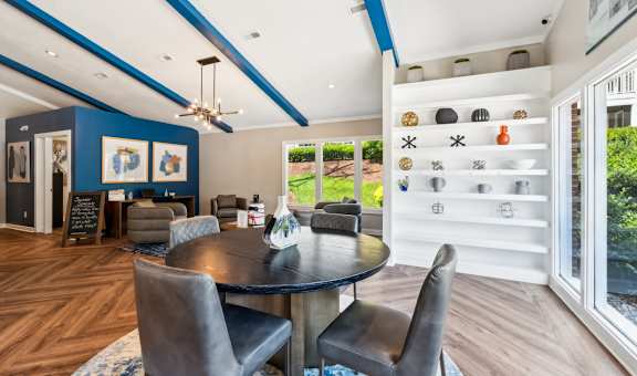 A modern dining room with a round table and chairs. at Woodcreek Apartments, North Carolina