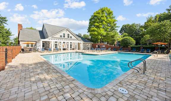 a swimming pool with a house in the background at River Oak Apartments, Louisville, KY, 40206