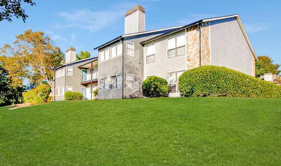a house on top of a lush green lawn at Edgemont Apartments, PRG Real Estate, Greenville, 29615