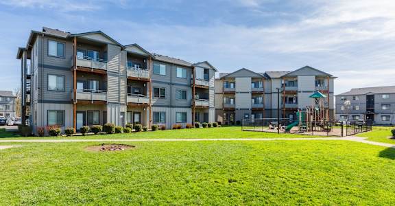 Apartment complex with a playground in the front yard.