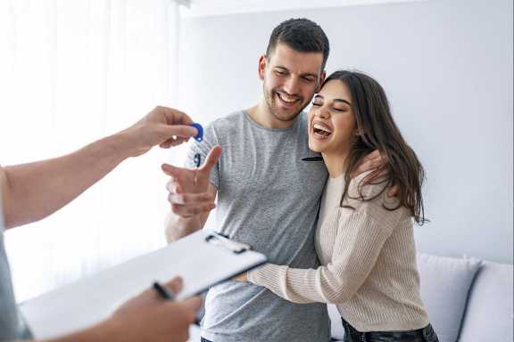 A man is giving a woman a blue pill bottle.