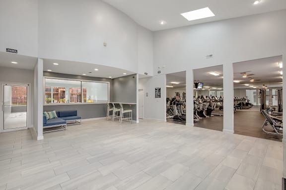 A spacious room with a white interior and a grey floor.