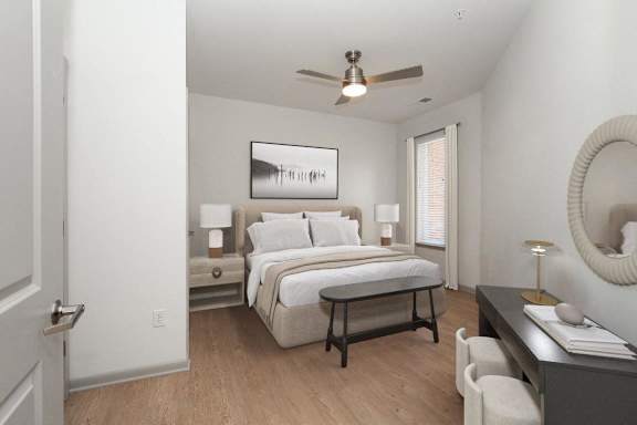 a bedroom with a bed and a ceiling fan