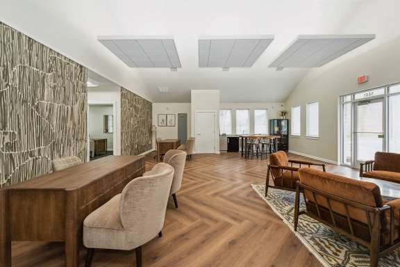 A room with a long wooden table and chairs.