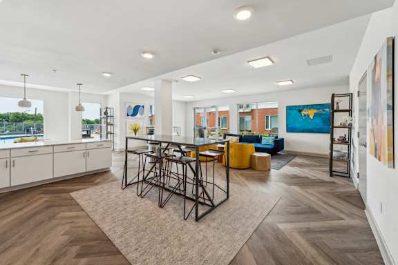 A modern living room with a dining table and chairs.