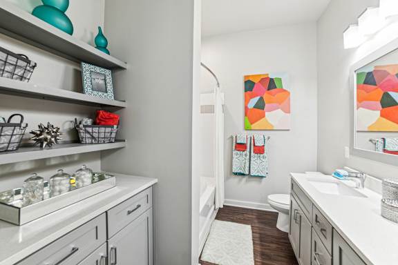 A bathroom with a white sink and a white toilet.