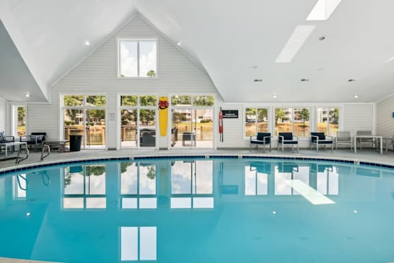 A large indoor swimming pool with a glass bottom.