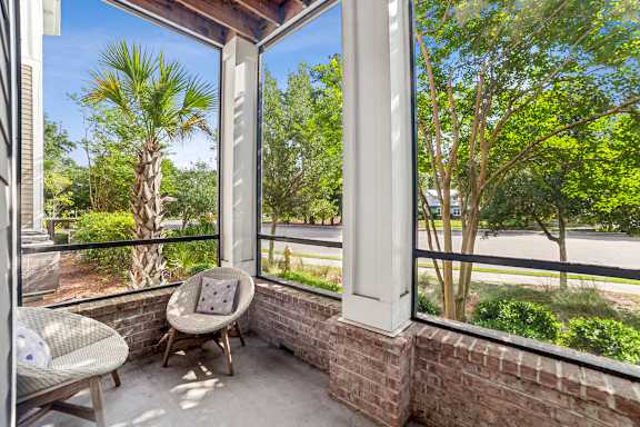 A balcony with a chair and a table.