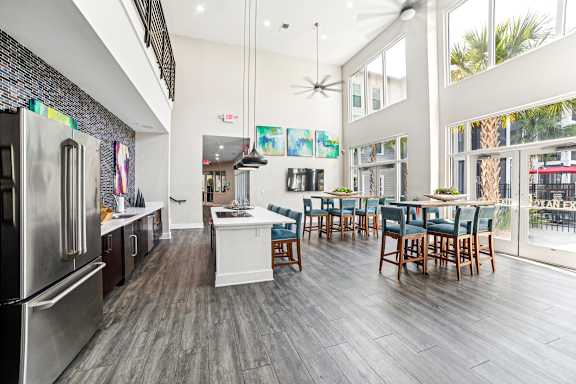 A modern kitchen with a dining table and chairs.