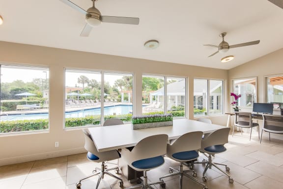 A room with a table and chairs and a ceiling fan at The Villages Apartment of Bayan Grove in Boynton Beach, FL