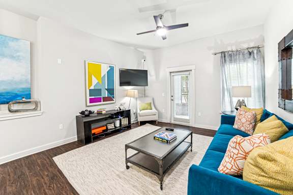 A living room with a blue couch and a coffee table.